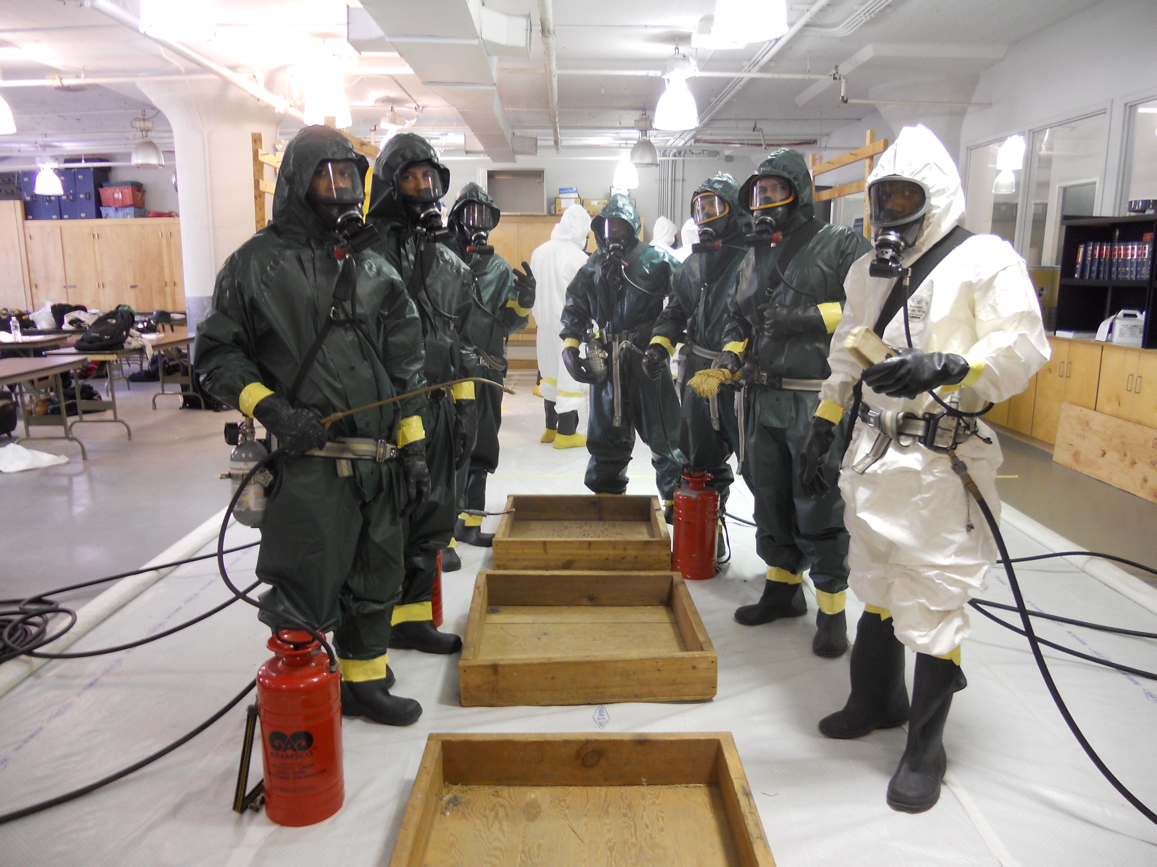 Students wearing HAZMAT suits during a training simulation and exercise. (Photo courtesy of Joan Staunton, Atlantic Center for Occupational Health and Safety).